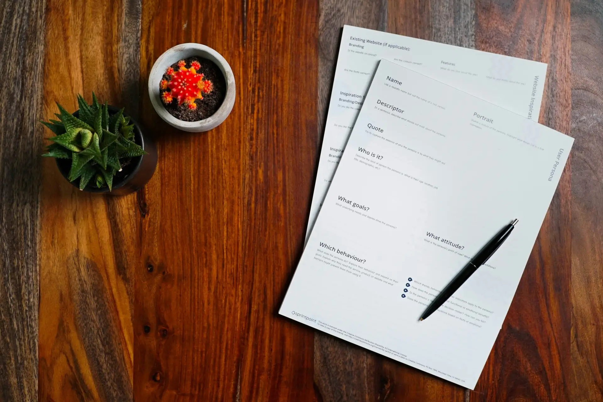A signed supplier agreement and a pen on a wooden desk